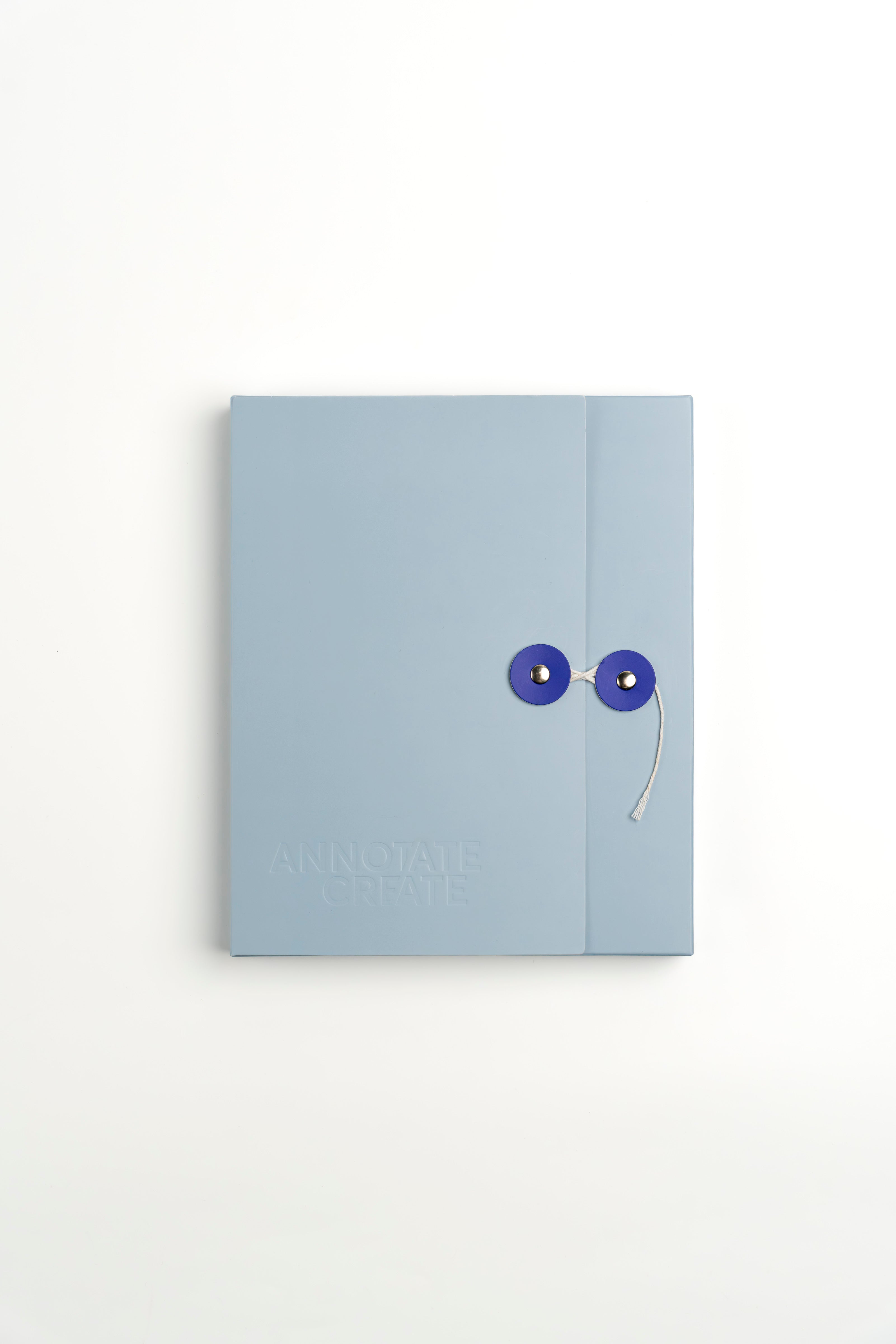 Nōto notebook's baby blue protective storage case with button-and-string closure